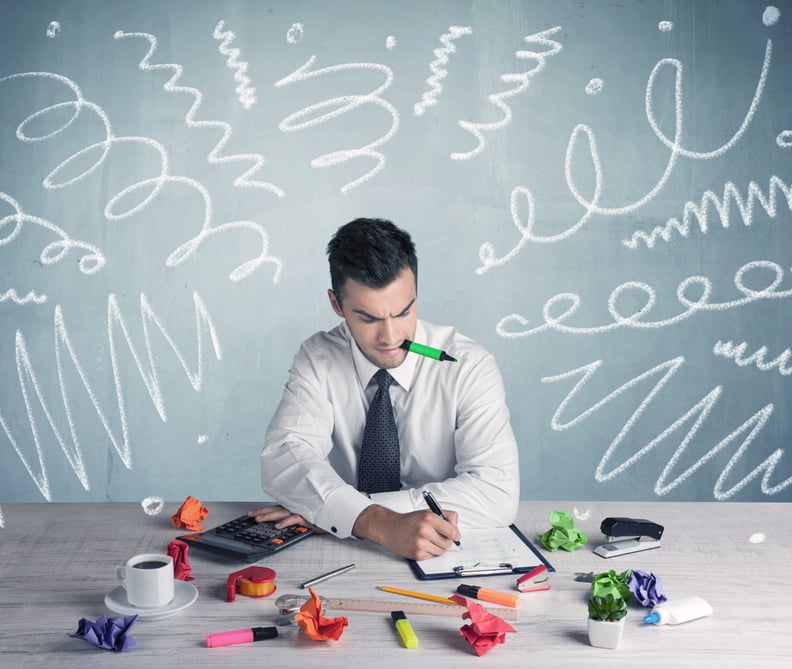 An elegant businessman sitting at office desk and working on keyboard with drawn curves, lines illustration on background wall concept