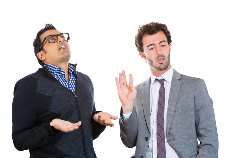 Closeup portrait, annoyed nerd man with black glasses by what a business guy in suit is telling him, talk to hand, isolated white background. Negative human emotion facial expression feelings.