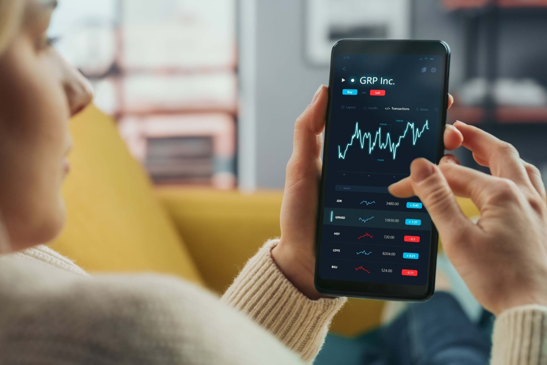 A Millennial investor reviewing financial data on a smartphone, illustrating the digital referral concept.